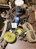 Overview of tie straps, locking cables and bungee cords on wooden surface