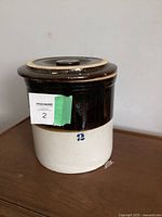 Front and side view of the brown and white ceramic crock showing its overall color scheme and the number '2' marking.