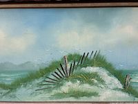 Close-up detail of the sand dune with grasses, wooden fence, and flying seagulls in the oil painting.