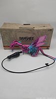 Photo of Disney Banshee Rookery Avatar Pandora banshee puppet with controller and box behind it
