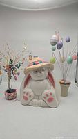 Overall lot with two Easter tree decorations and one ceramic rabbit cookie jar wearing colorful hat