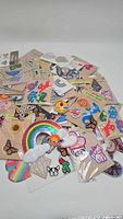 Image showing a spread of various colorful patches including rainbow, butterflies, animals, and emoji