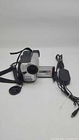 Samsung SCL901 8mm Hi8 camcorder, lens cap, power adapter charger and hand strap visible