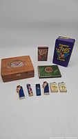 Overview of all items including cigar box, tobacco tins, and lighters arranged on a surface