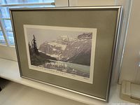 Framed print resting against window, showing full artwork and frame.