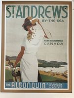 Unframed full view of the print showing woman golfer with polo shirt and hat standing by seaside with hills and water