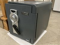 Front and side view showing grey steel exterior and First Alert badge