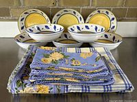 Full set of tablecloth, napkins, and pasta bowls arranged for overview