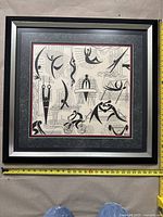 Front view of the framed artwork showing the full piece and measuring tape showing dimensions.