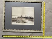 Full view of artwork in decayed white decorative frame with measuring tape showing dimensions about 25 inches wide.