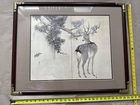 Full image of framed Asian art showing deer and pine branches with measuring tape to indicate size.