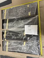 Set of five long rectangular Asian-style artwork panels wrapped in plastic and taped, showing overall length and width with measuring tapes.