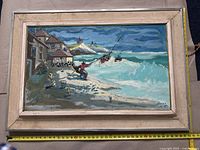 Full frontal view of framed painting with measuring tape at bottom