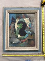 Framed painting front with tape measures showing overall size