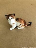Front-side view of Royal Doulton calico kitten figurine with clear details of color and expression.