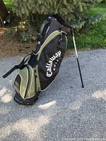 Side view showing the entire Callaway Big Bertha golf bag standing with legs extended, displaying the olive green and black color and the Callaway logo.