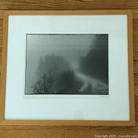 Frontal image of the framed signed black and white photo showing 'Foggy Road Home' scene, with wood frame and white mat.
