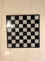 Full view of the onyx checker/chess board the lot is comprised of, showing the alternating black and white onyx squares arranged in a standard 8x8 grid.