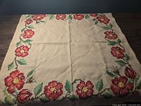 Top view of the fabric centerpiece showing the floral vine border around the perimeter.