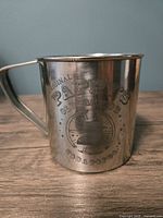Front side of the stainless steel mug showing the etched Pappy's Olde Fashion Soda Pop Co. logo and text.