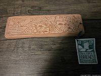 Top side of ceramic bread warmer showing engraved design with "Beautiful Bread" text and harvest imagery.