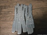 Top view showing the metal asparagus design with textured details on the trivet.