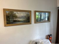 Framed pastel landscape painting displayed on wall, shown next to adjacent mirror-frame