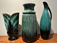 Three vintage Green and Black glazed ceramic Blue Mountain pottery pieces arranged for display.