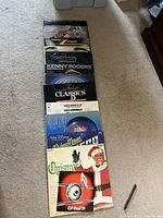 Photo showing all 11 vinyl records laid out on carpet including albums by Kenny Rogers, Supertramp, ZZ Top, Journey, Liza Minnelli, and a Christmas-themed album.