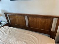 Front view of wooden full/queen headboard with panel design