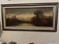 Full view of framed pastel evening landscape painting in silver-toned wooden frame