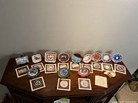 Full set of 12 miniature plates arranged on table with stands and labeled cards