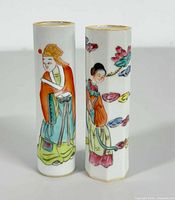 Front view of two hand-painted Chinese porcelain bud vases showing traditional figures and floral designs.