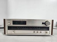 Front view of Sony ST-3950SD tuner showing analog frequency scale, power button, tuning knob, and control switches.