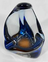 Front view of the Murano art glass ashtray showing its abstract freeform shape and deep blue, black, and clear glass color variations.