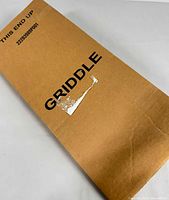 Photo of original cardboard packaging labeled 'GRIDDLE' with condition showing factory new, unopened item.