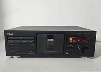 Front view showing cassette well, control buttons, LED display reading timer, headphone jack and level controls