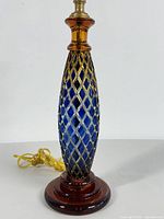 Close-up of the blue crystal lamp body with amber-colored base and diamond lattice pattern