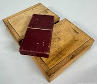 Three storage cases: two wooden sliding-lid boxes and one maroon hinged box.