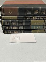 Five Britannica Great Books volumes stacked, showing spines of volumes 20 to 24 with leatherette binding and gilt detailing, identified as Thomas Aquinas I/II, Dante, Chaucer, Machiavelli/Hobbes, and Rabelais.