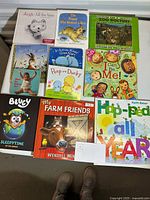 Eleven children's books arranged in rows showing titles and cover art distinctly including Bluey: Sleepytime and My Farm Friends.