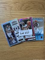 Photo displaying three basketball cards including Stephen Curry Season Ticket, Bam Adebayo, and a Splash! card showing a Cleveland Cavaliers player.