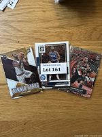 Photo showing three basketball cards featuring LeBron James Winner Stays, James Harden, and Damian Lillard Express Lane designs.