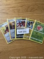 Top view of 5 Pokémon cards fanned out showing Trainer Lance, Krookodile, Maractus and others