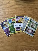 Photo of 5 Pokémon cards from the lot, showing variety of characters and trainers in English language.