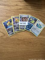 Lot of assorted Pokémon cards including Radiant Jirachi, Radiant Steelix, Unidentified Fossil Trainer card, and others.
