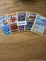 Photo of 5 Pokémon cards from the lot including Toxel, Torracat, Dragapult, Krookodile, and Tsareena, showing mixed English and Japanese text cards.