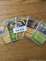 Display of five Pokémon cards featuring Pawmot, Spewpa, Wattrel, Klawf, and Shiinotic, all sleeved in protective plastic.