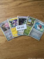 Front view of five Pokémon cards displayed in sleeves, including Blissey, a Japanese card, Cylizar, Seedot, and Poké Ball Trainer card.