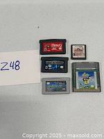 Five vintage Nintendo game cartridges from multiple systems arranged on a white surface with a label 'Z48' visible.